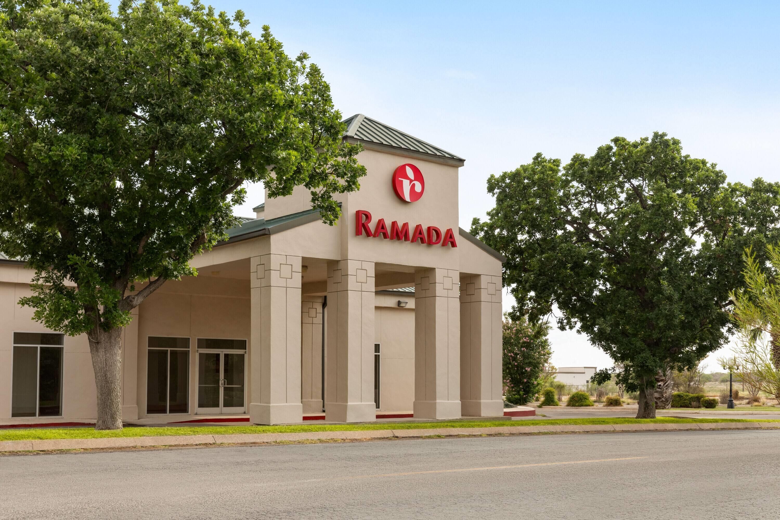 A building with a sign reading "RAMADA" and a logo above it.