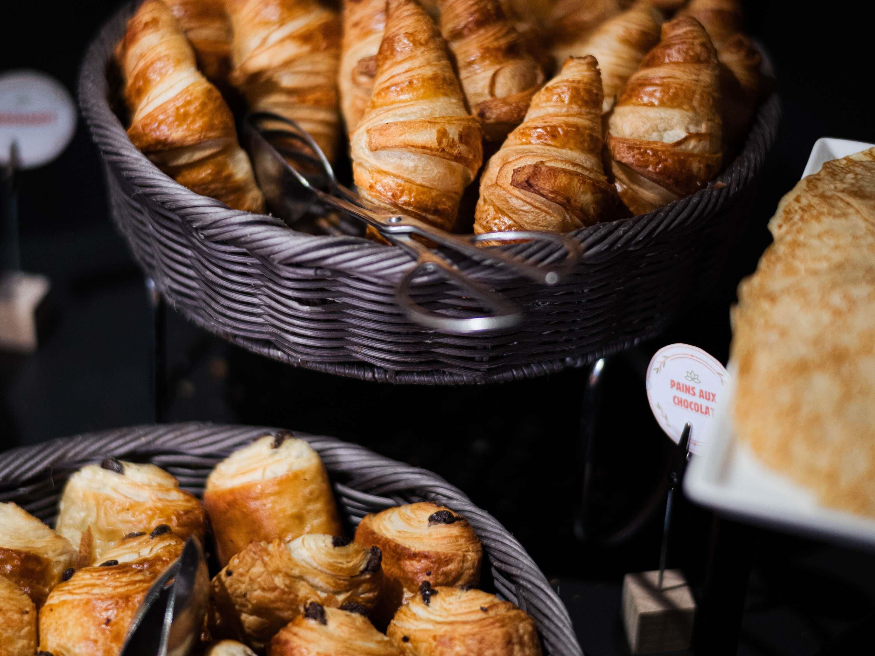 A display of pastries in wicker baskets.