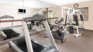 A gym with treadmills, elliptical machines, and weight equipment.