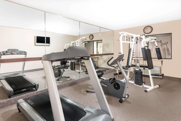 A gym with treadmills, elliptical machines, and weight equipment. - Ramada by Wyndham Vandalia (Vandalia)