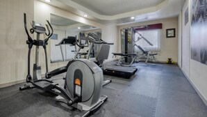 A gym with treadmills, elliptical machines, and weight benches. - Best Western The Inn At Rochester Airport (Rochester)