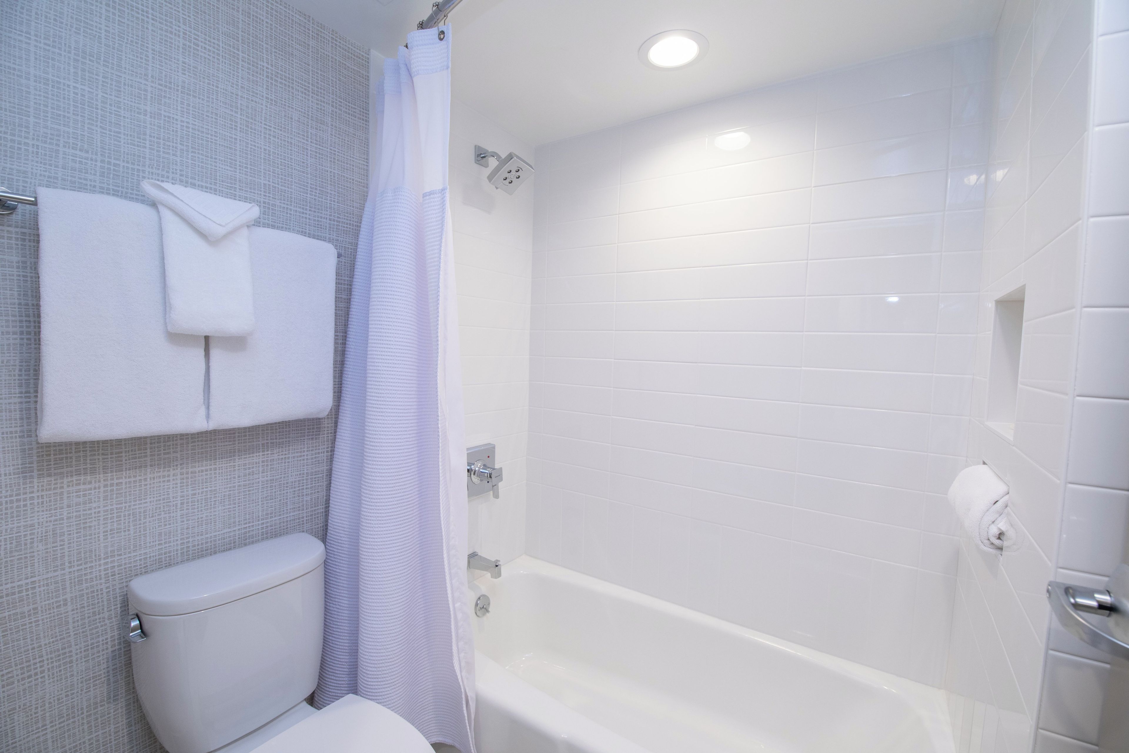 A bathroom with a toilet, a shower, and a bathtub.
