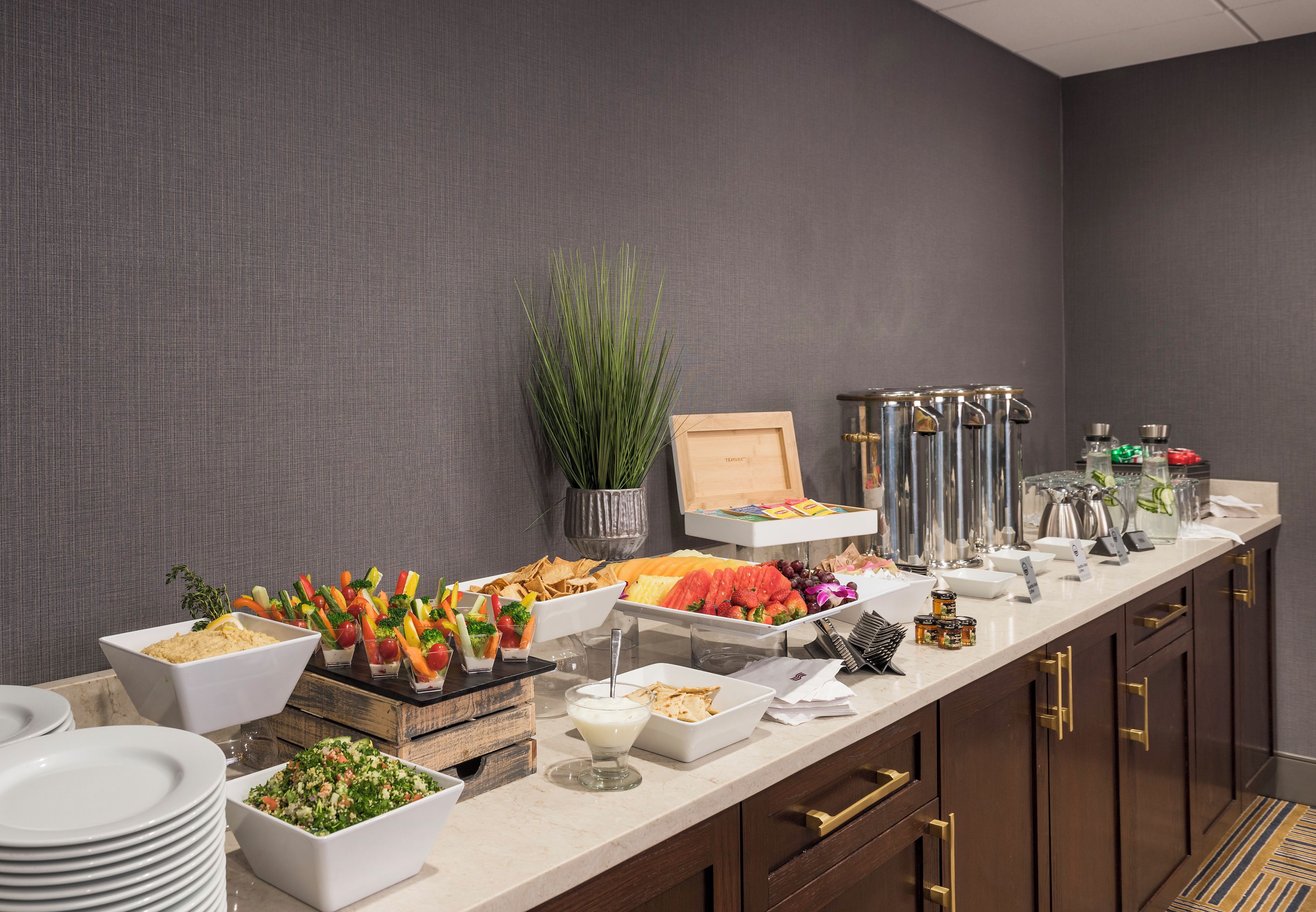 A buffet setup with various food items and beverages.