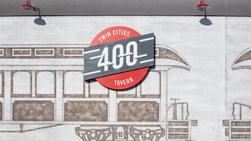 A wall mural with a train and a sign that reads "Twin Cities 400 Tavern."