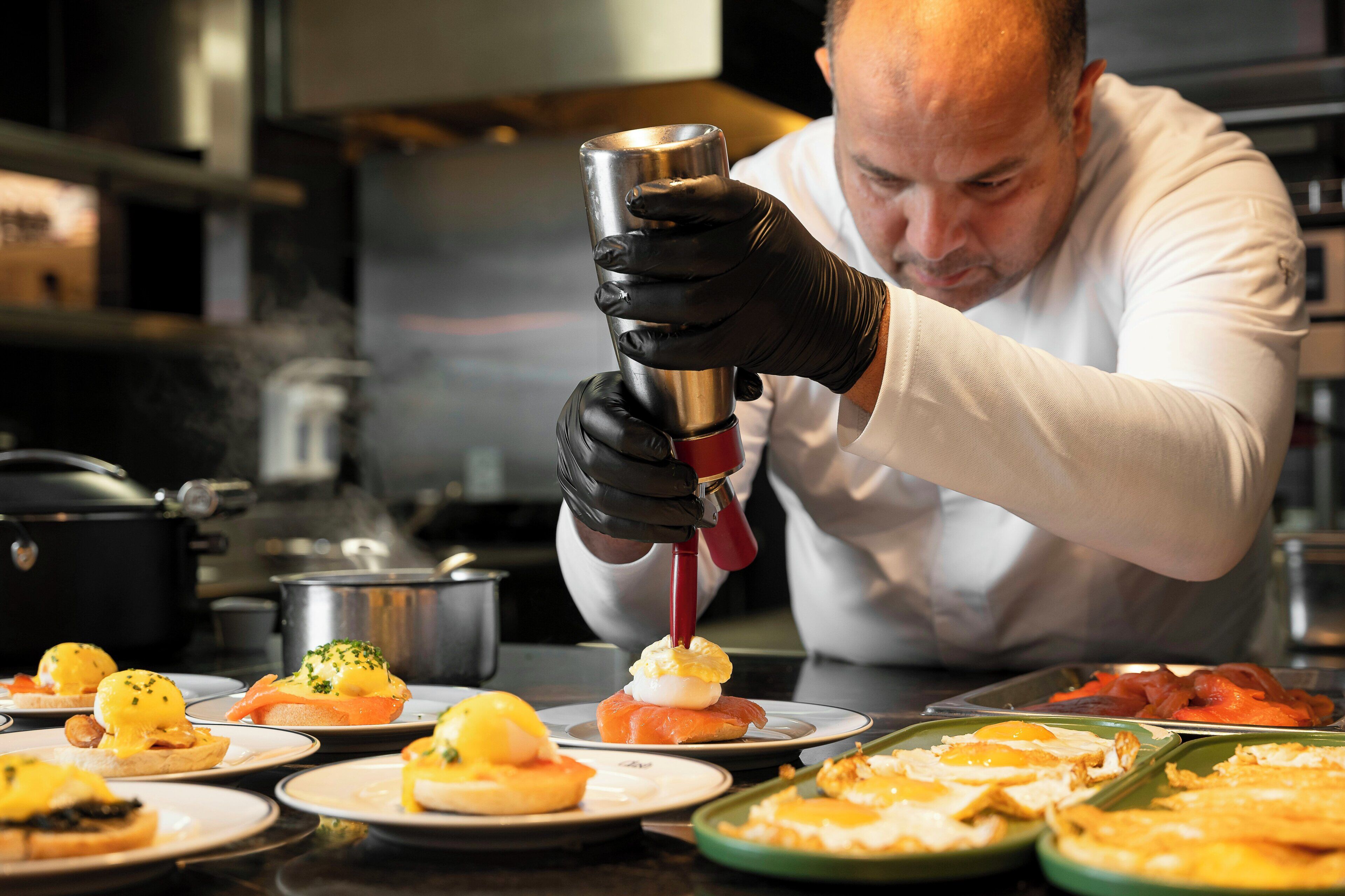 A chef preparing food in a kitchen.