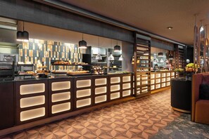 Un área de cocina moderna con un mostrador que exhibe productos horneados y un salpicadero de azulejos.