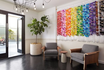 A gym with treadmills, a stationary bike, and dumbbells. at Kimpton Hotel Enso by IHG