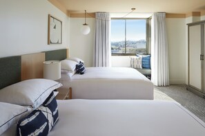 A hotel room with two beds, a large window with curtains, a view of the city, and a wardrobe. - Kimpton Hotel Enso by IHG (San Francisco)