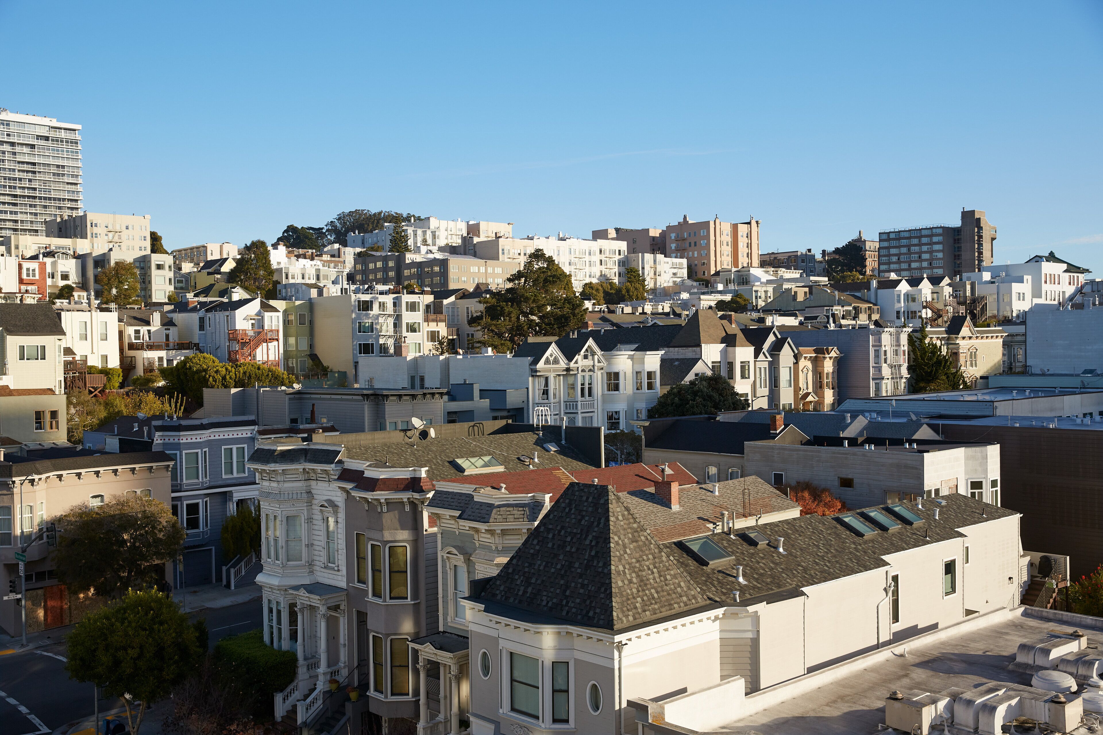 A densely packed urban area with a variety of building styles, including Victorian and modern architecture.