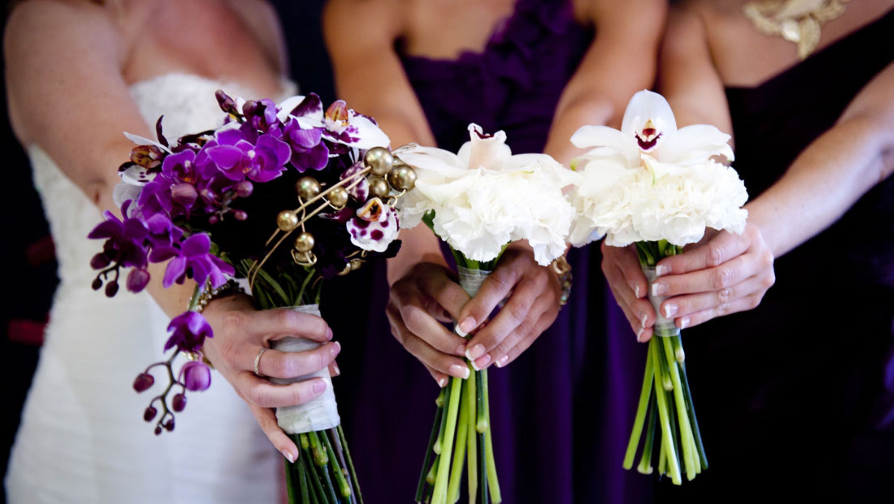 A group of individuals holding bouquets of flowers.