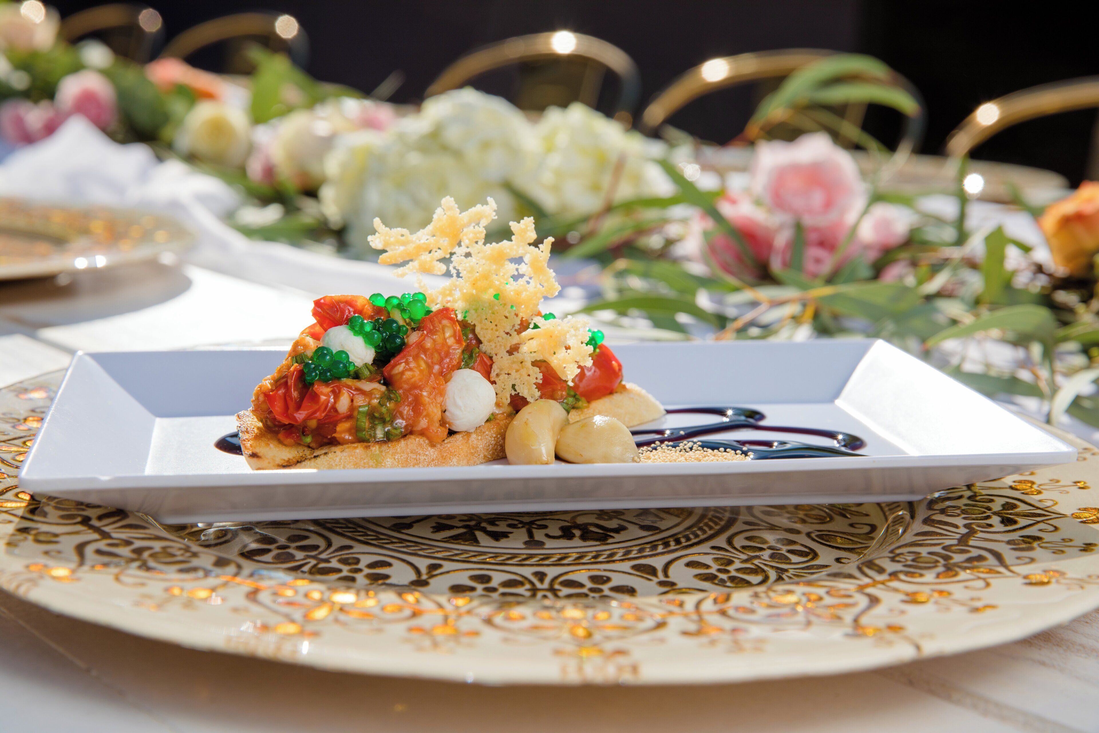 A plated dish with various food items and a decorative plate with a geometric pattern.