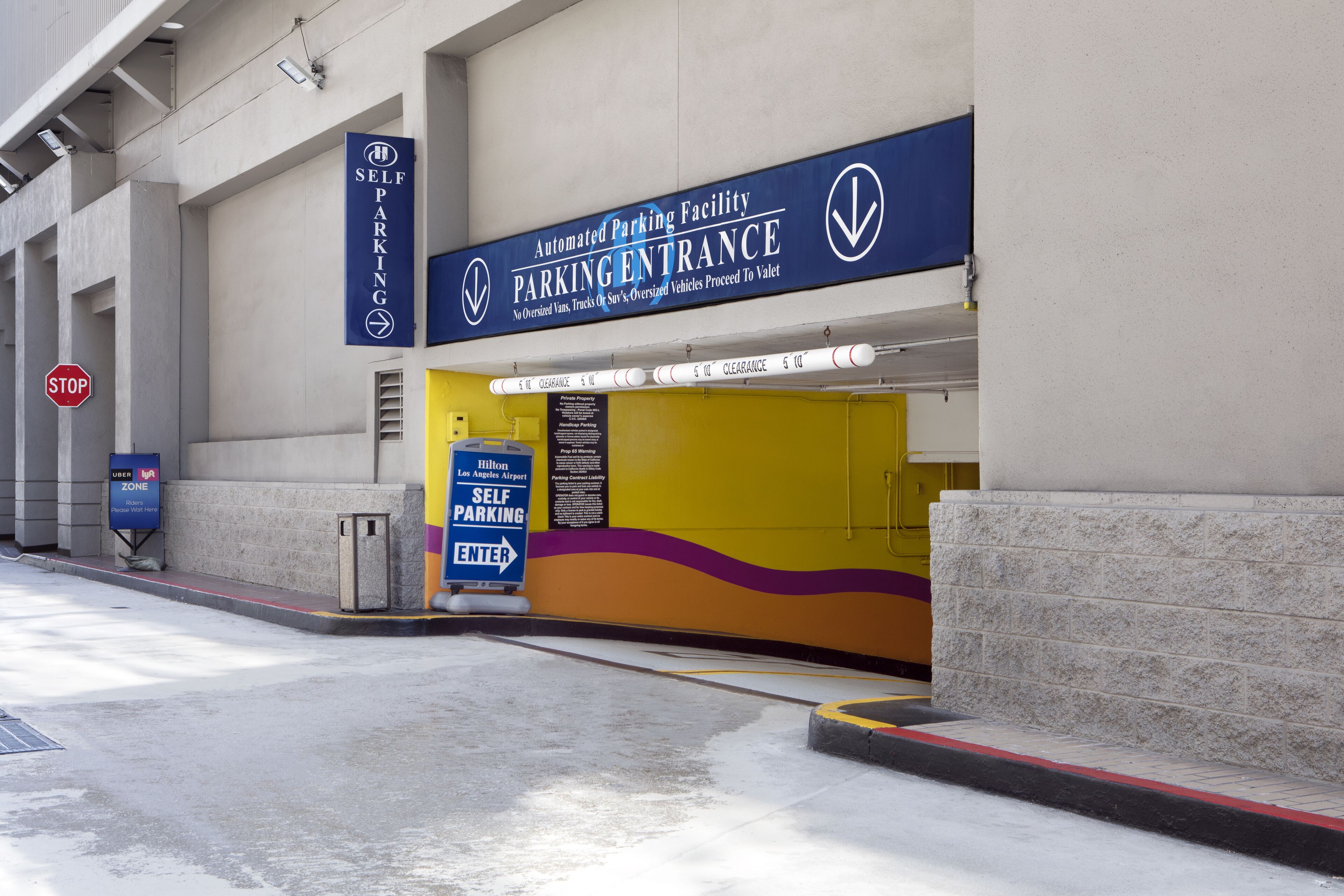 An automated parking facility entrance with clear signage directing to valet services.