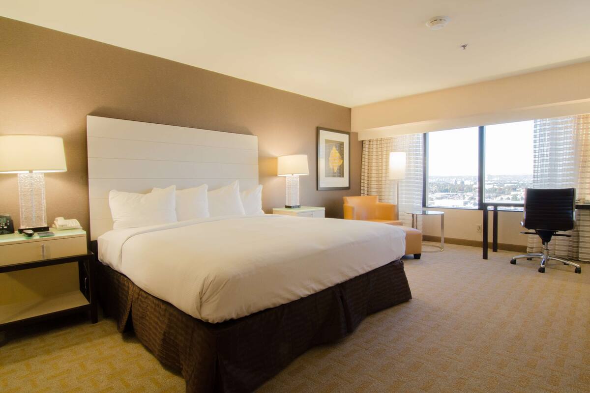 deluxe room, 1 king bed | premium bedding, pillow-top beds, in-room safe, desk