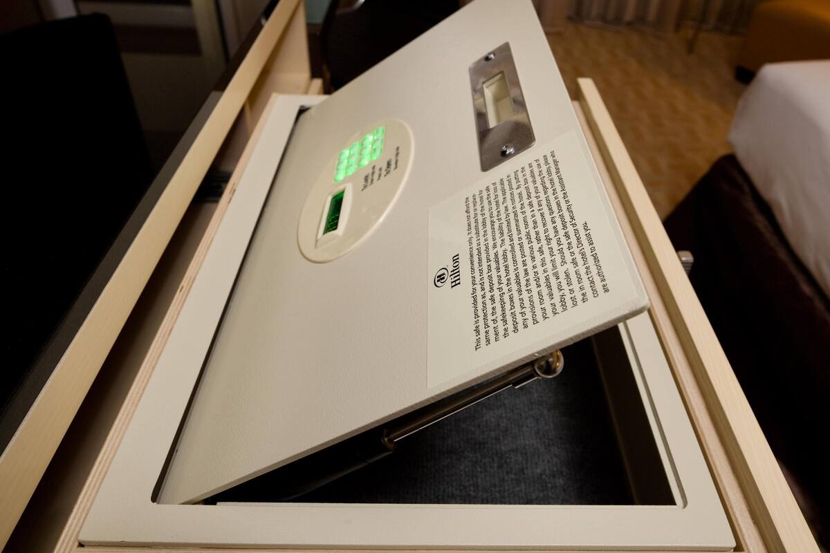 A digital scale with a display and a manual.