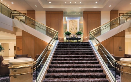 A grand staircase with marble steps leading to a reception area.