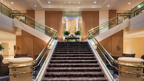 A grand staircase with marble steps leading to a reception area. - Hilton Los Angeles Airport (Los Angeles)