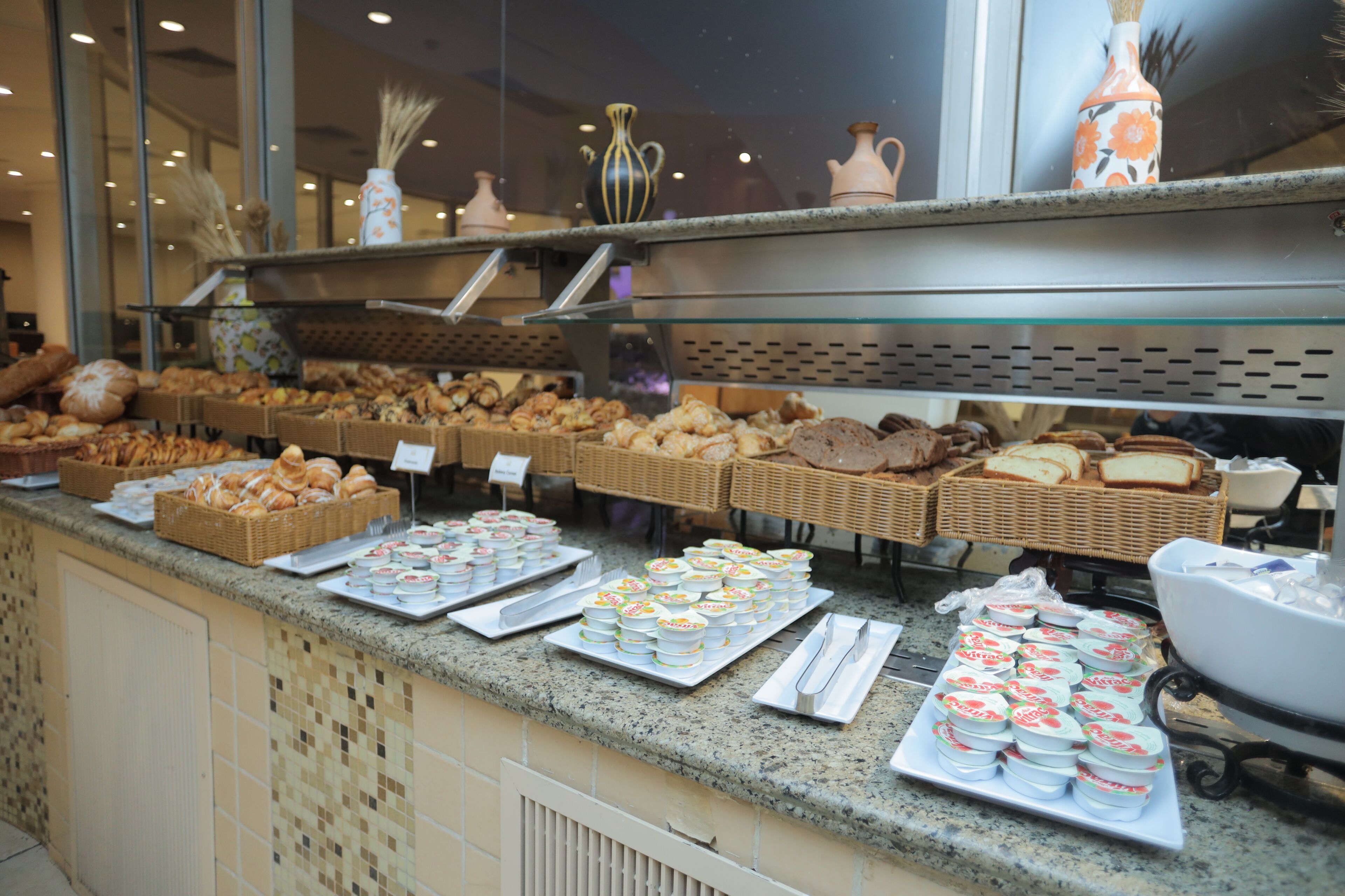 A buffet counter with various food items and a baby changing station.