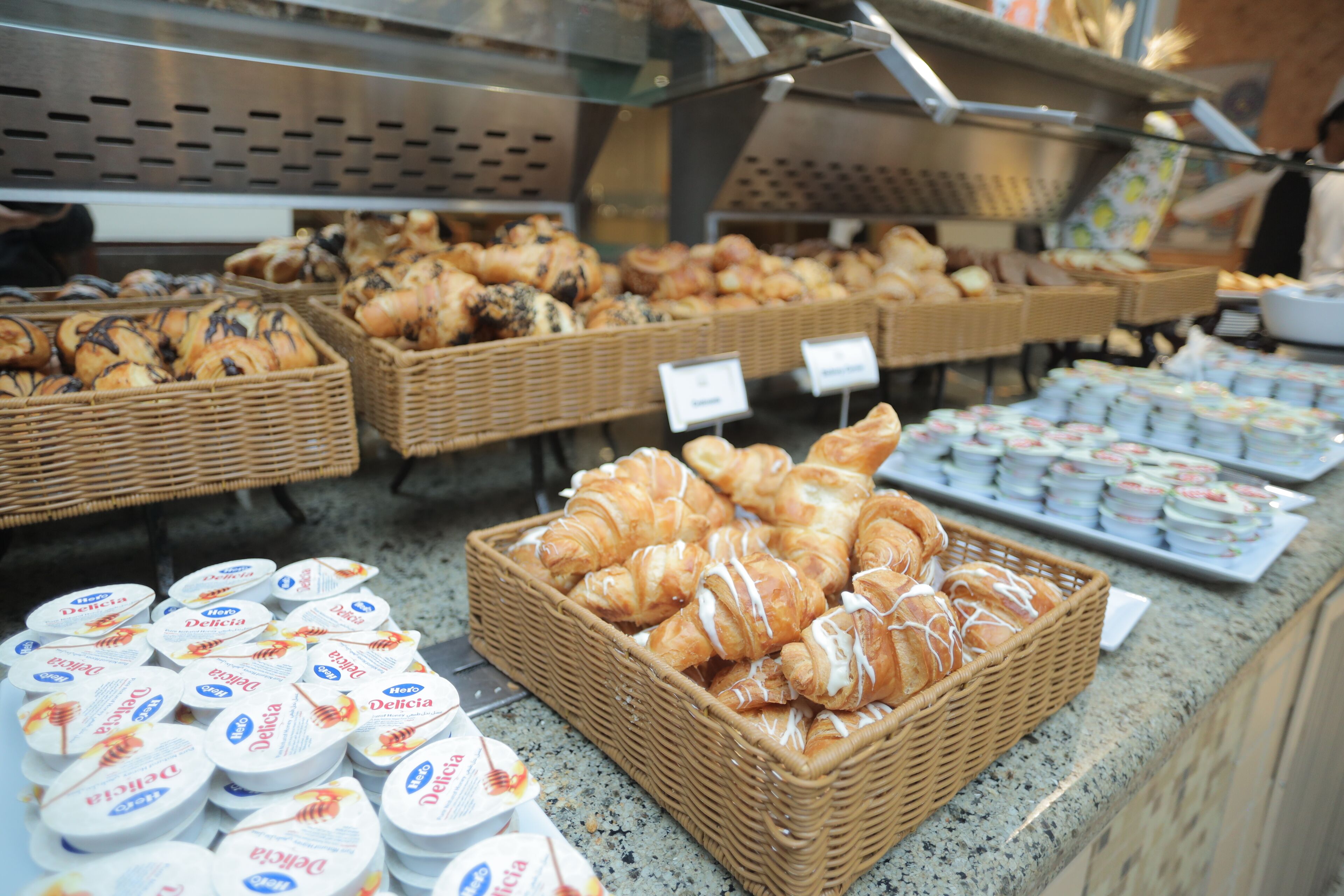 A bakery display with various baked goods and packaged items.