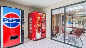 A vending machine with Pepsi and Coca-Cola logos, a Coca-Cola bottle image, and a selection of drink options. - Quality Inn Oakwood - Gainesville (Flowery Branch)