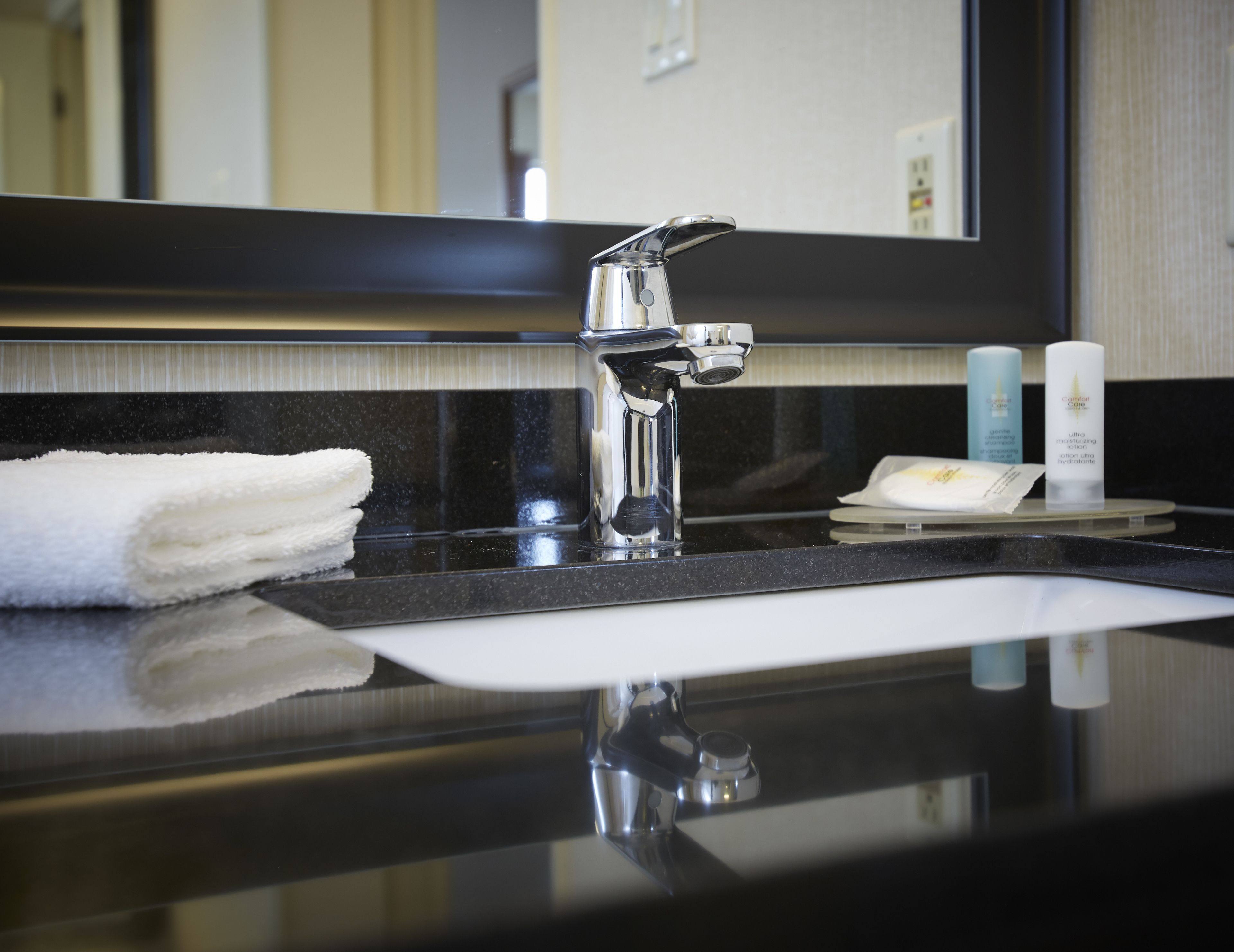 deluxe room, 2 queen beds, refrigerator & microwave, ground floor | bathroom | combined shower/bathtub, eco-friendly toiletries, hair dryer, towels