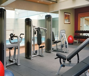 A gym with exercise equipment, a bench, and a red exercise ball. - Hilton Boston Back Bay (Boston)