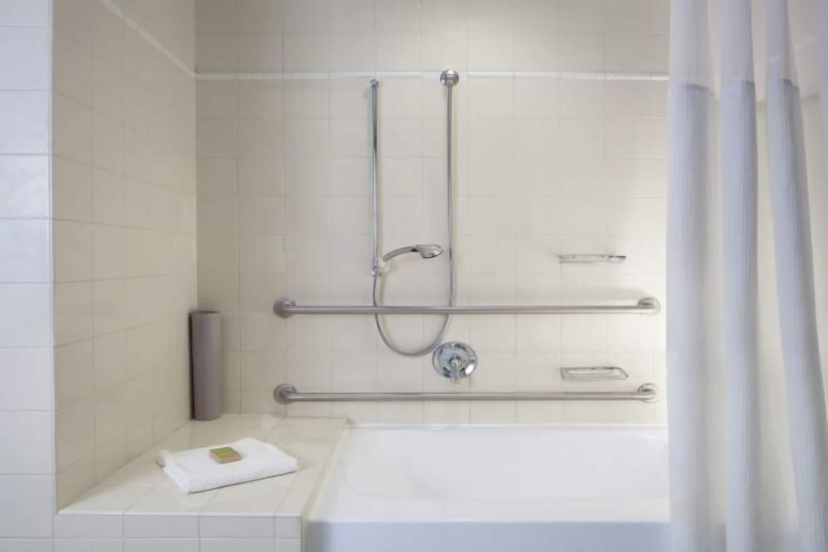 Shower, designer toiletries, hair dryer, towels