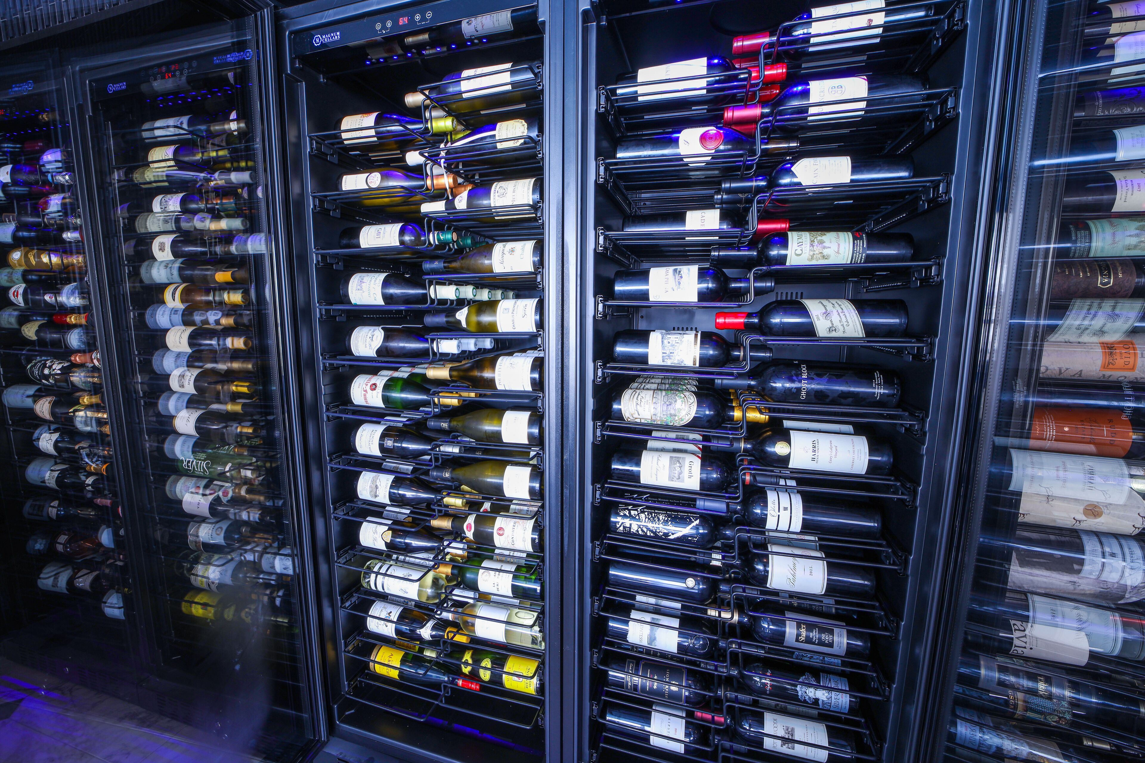 A wine cellar with multiple racks of wine bottles.