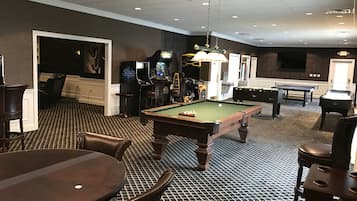 Relax and unwind in our indoor recreational area, featuring a pool table, foosball table, and ping pong table.