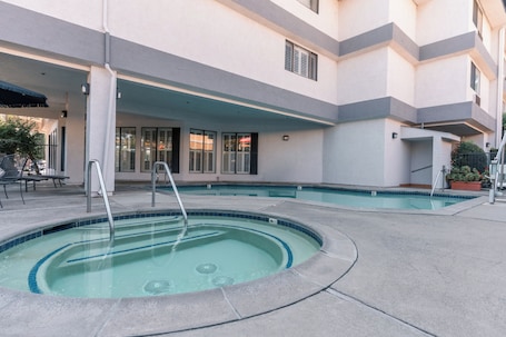 Outdoor pool, pool umbrellas, sun loungers. Governors Inn Hotel
