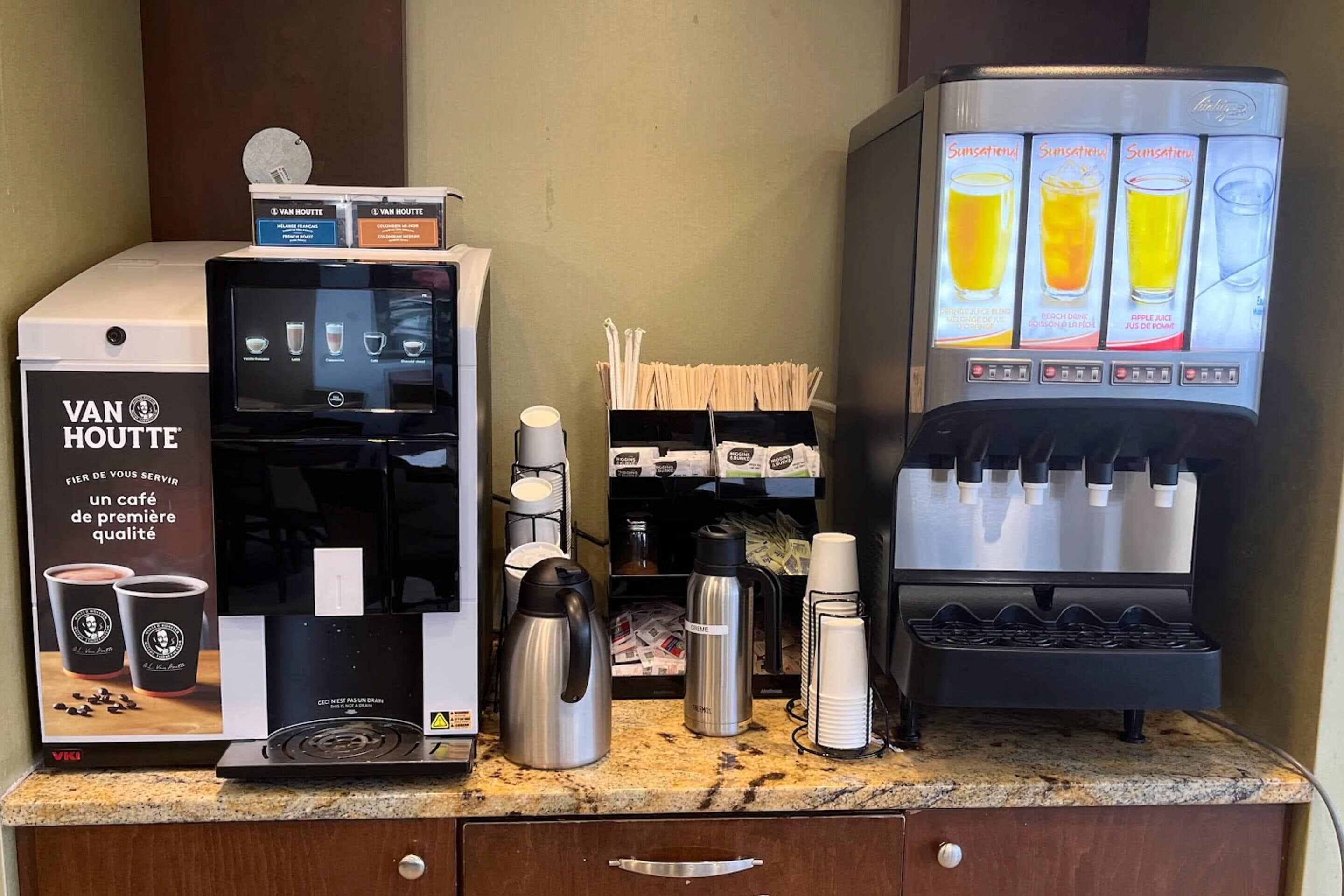 A coffee machine, a beverage dispenser, and a coffee maker on a counter.