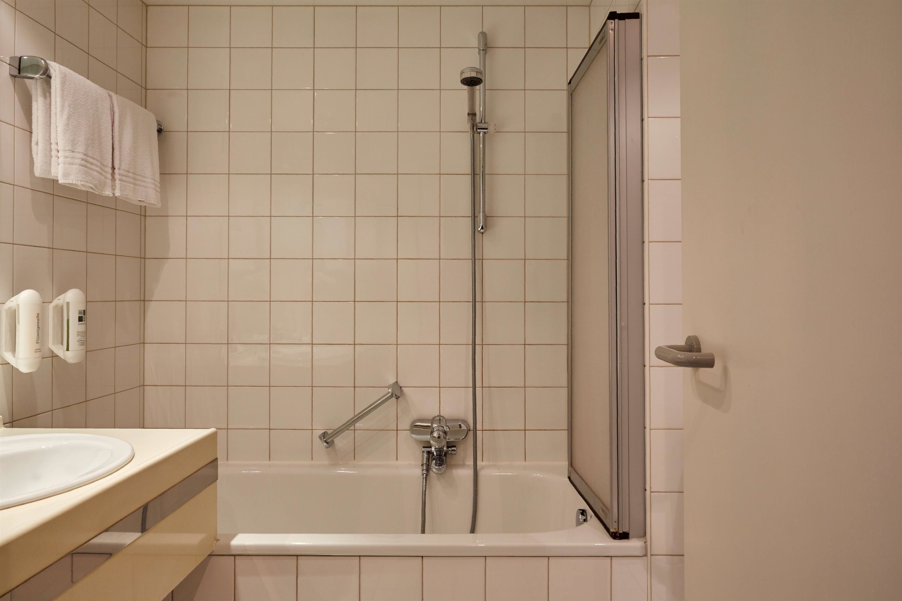 combined shower/bathtub, hair dryer, bathrobes, towels