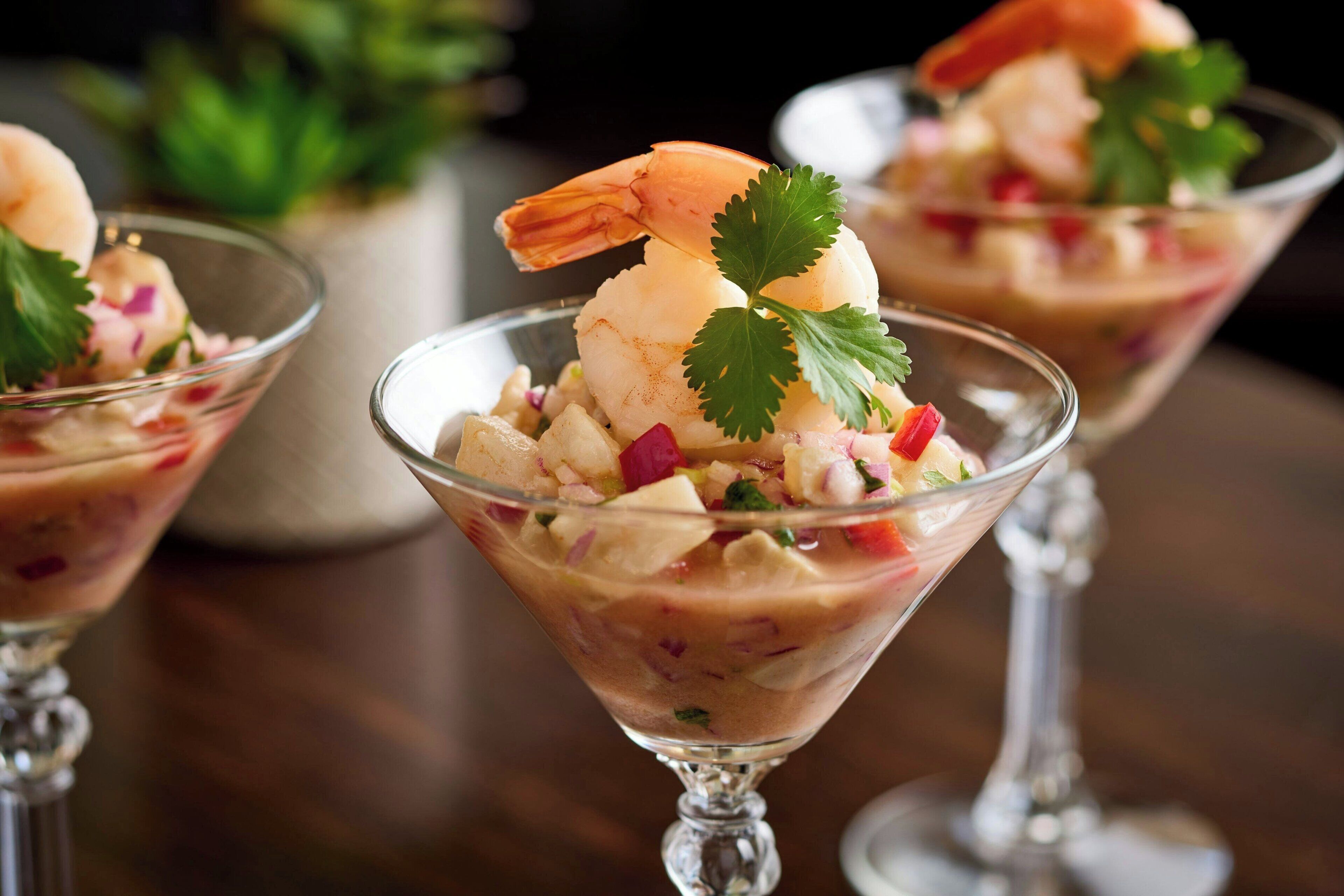 A dessert with a shrimp garnish and a leaf on top.