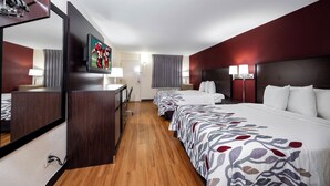 A hotel room with a large bed, a desk, a television, and a mirror. - Red Roof Inn Bordentown - McGuire AFB (Bordentown)
