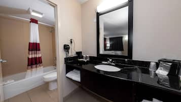A bathroom with a bathtub, toilet, and sink.