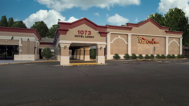 A hotel lobby with a large sign reading '1073 HOTEL LOBBY' and a Red Roof Inn sign. - Red Roof Inn Bordentown - McGuire AFB (Bordentown)