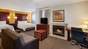 A hotel room with two beds, a TV, a fireplace, a desk, and a couch. - SenS Suites Livermore, SureStay Collection by Best Western (Livermore)