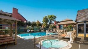 A rooftop pool area with lounge chairs, a hot tub, and a covered seating area. - SenS Suites Livermore, SureStay Collection by Best Western (Livermore)
