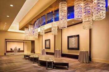 A modern lobby with a bar area, comfortable seating, and decorative wall art. at Renaissance Phoenix Downtown Hotel