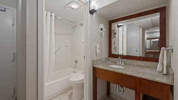 A bathroom with a bathtub, toilet, and sink.