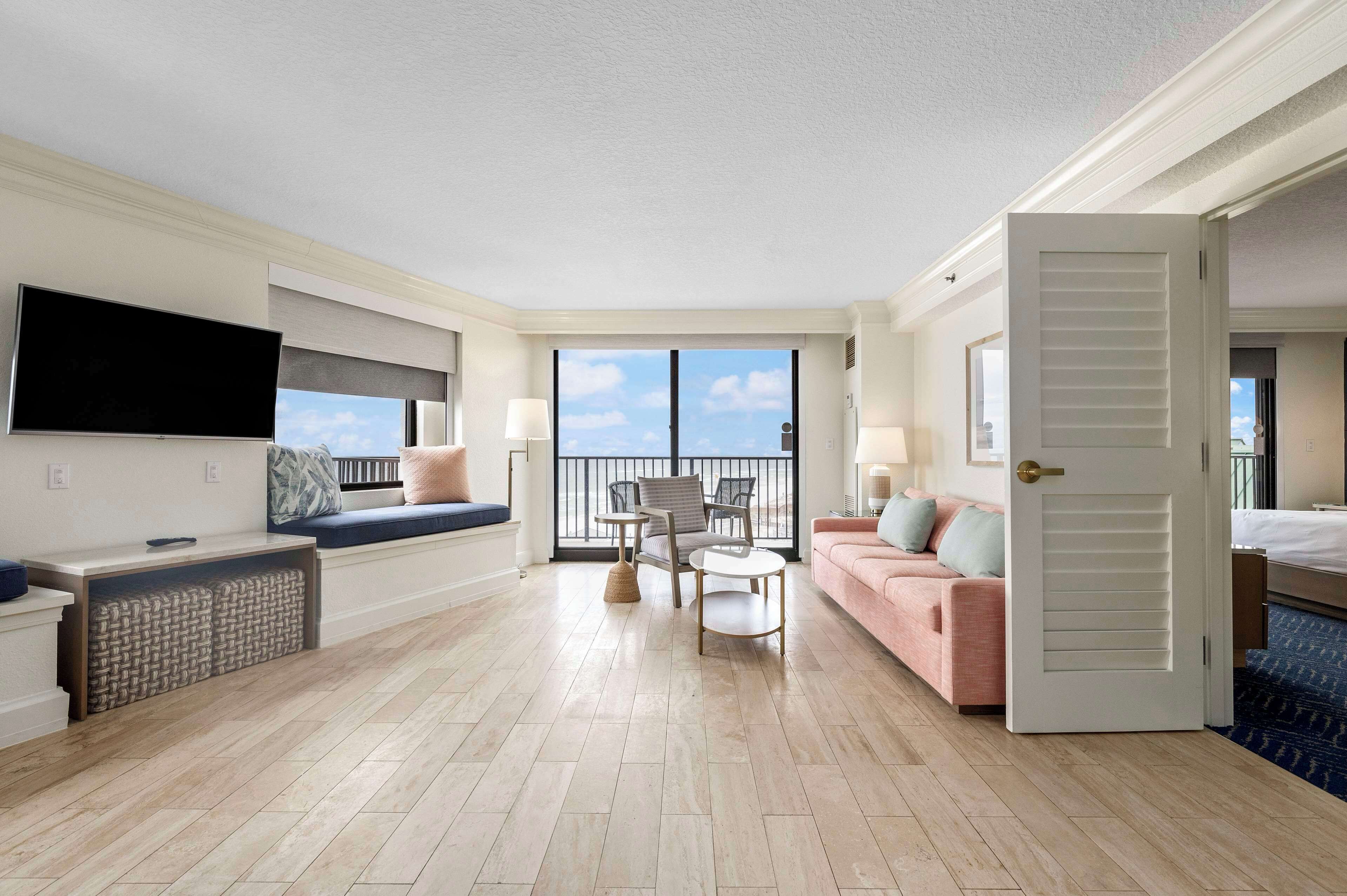 King Ambassador Suite, 1 King Bed | Living area | 65-inch TV with cable channels