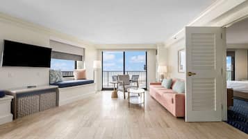 King Ambassador Suite, 1 King Bed | Living area | 65-inch TV with cable channels