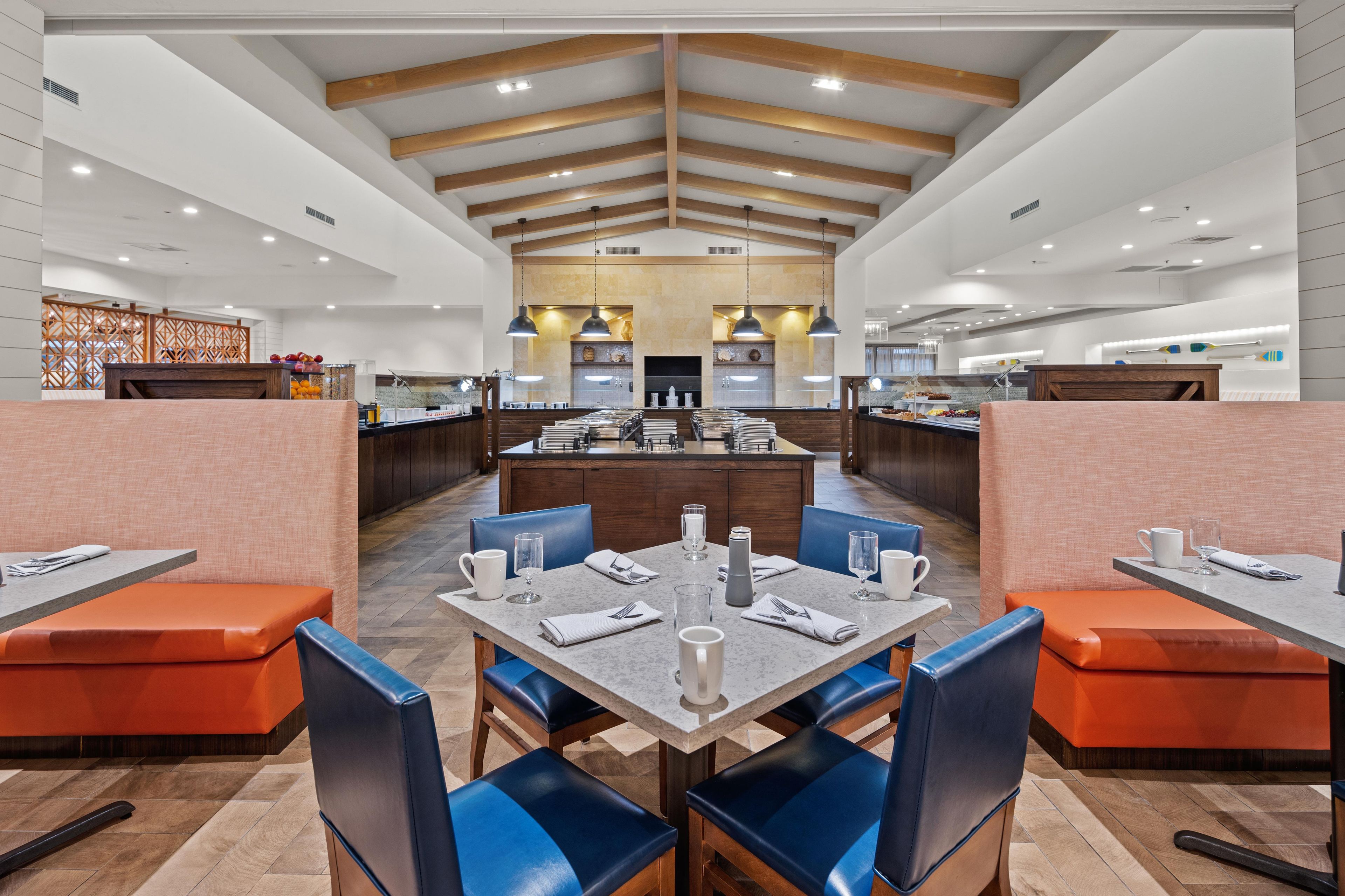 A restaurant with booths, tables, and a central island.