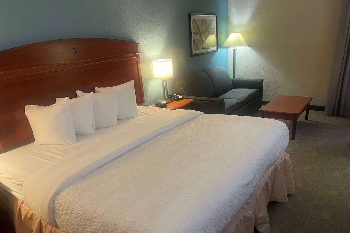 Premium bedding, desk, laptop workspace, blackout drapes