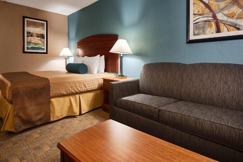 Premium bedding, desk, laptop workspace, blackout drapes