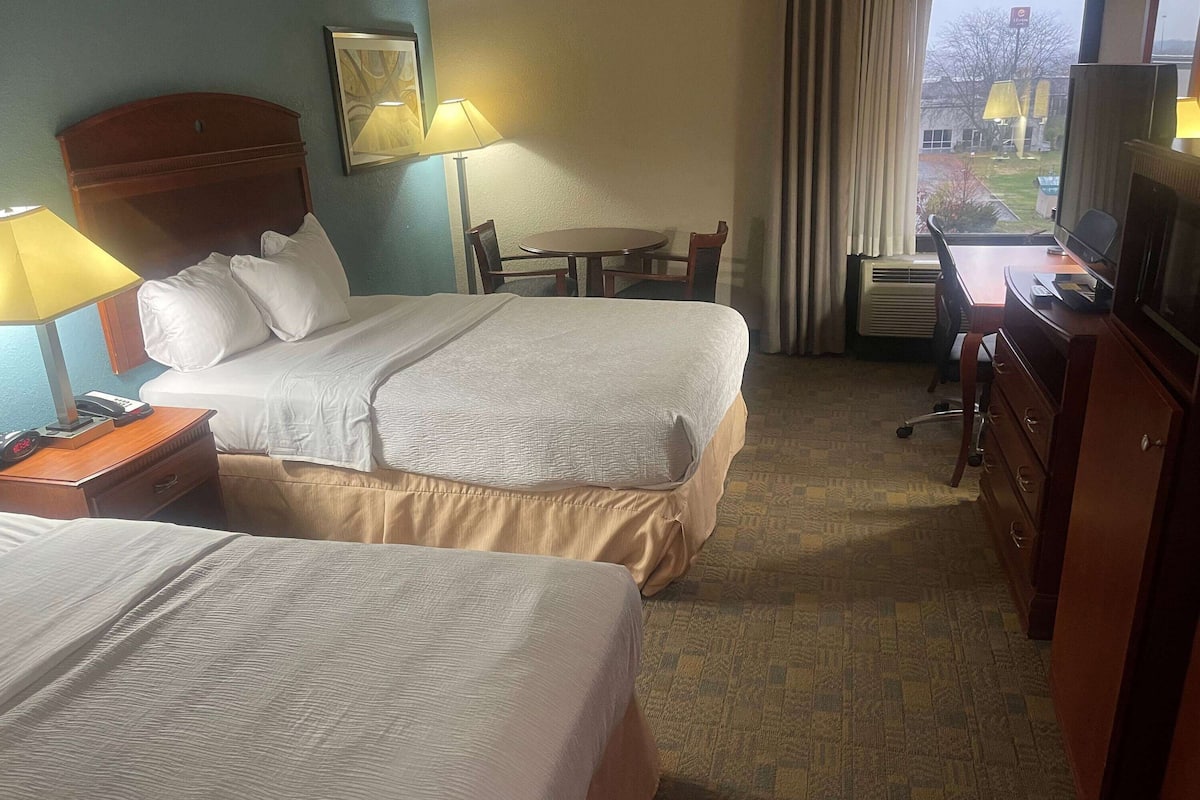 Premium bedding, desk, laptop workspace, blackout drapes