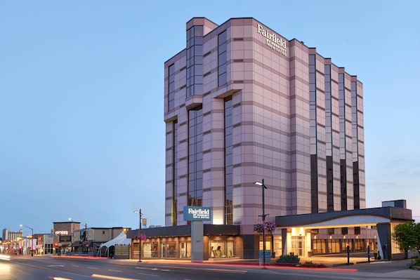 A multi-story hotel with a modern design, featuring a prominent sign for the Fairfield Inn & Suites.