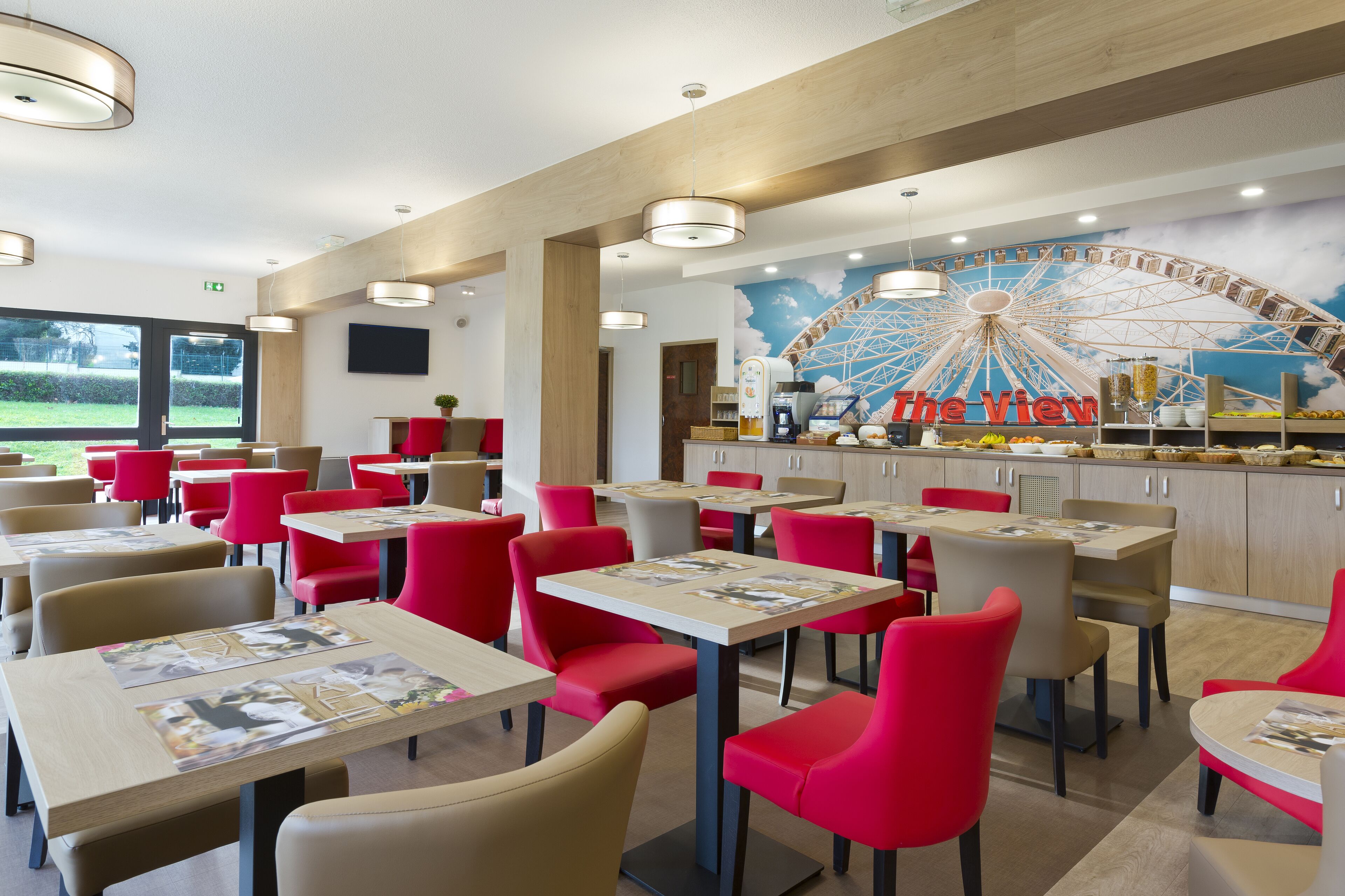 A restaurant with red chairs and tables, a Ferris wheel mural, and a counter with a sign reading "The View".