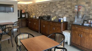 A compact kitchen area with a coffee station, a flat-screen TV, and a buffet setup. - Days Inn by Wyndham Jonesboro AR (Jonesboro)