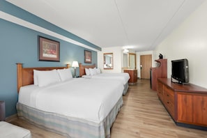A hotel room with a large bed, a TV, a dresser, and a mirror. - Quality Inn & Suites Black River Falls I-94 (Black River Falls)