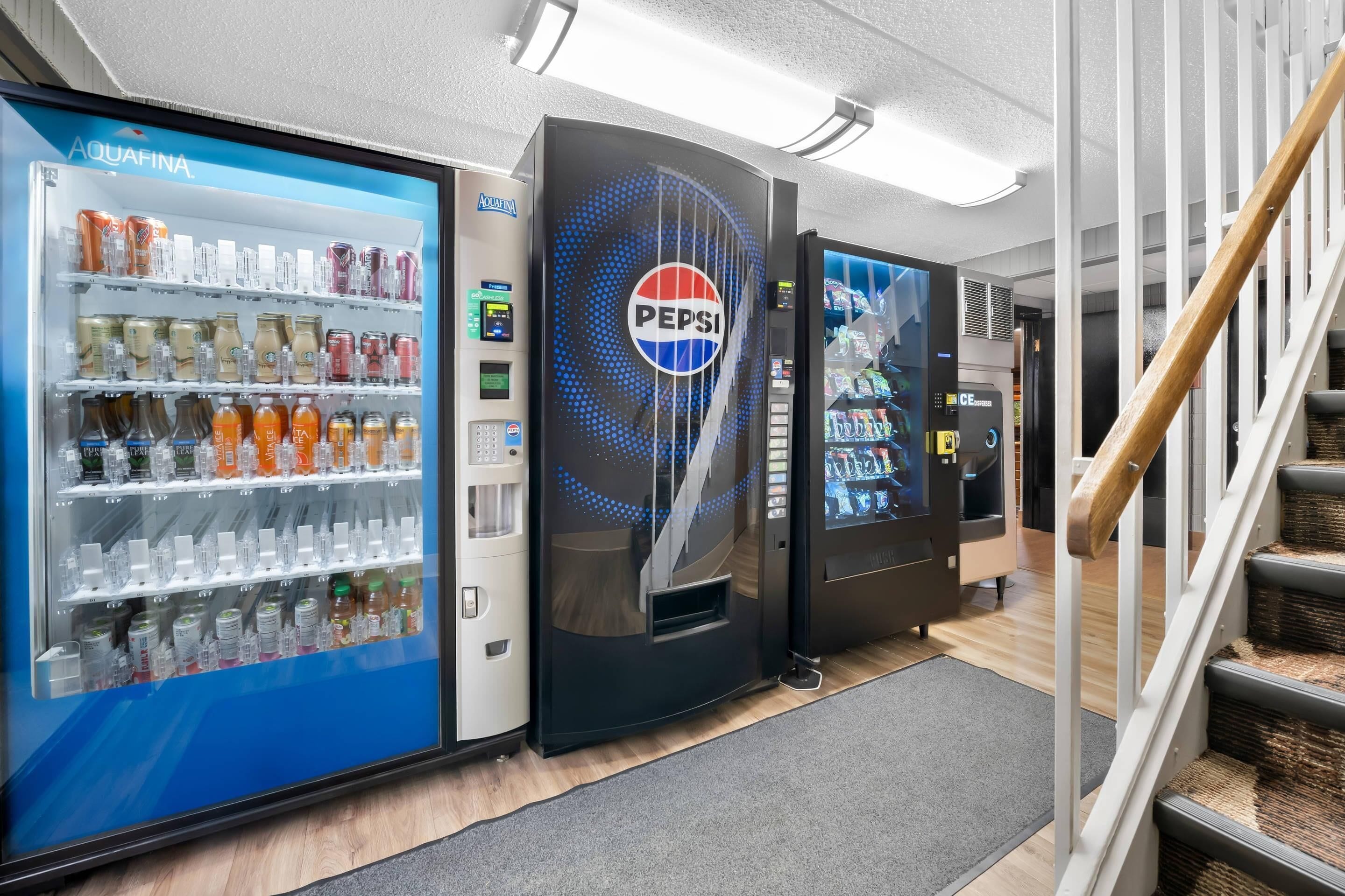 A vending machine area with a Pepsi logo, a water dispenser, and a CE machine.